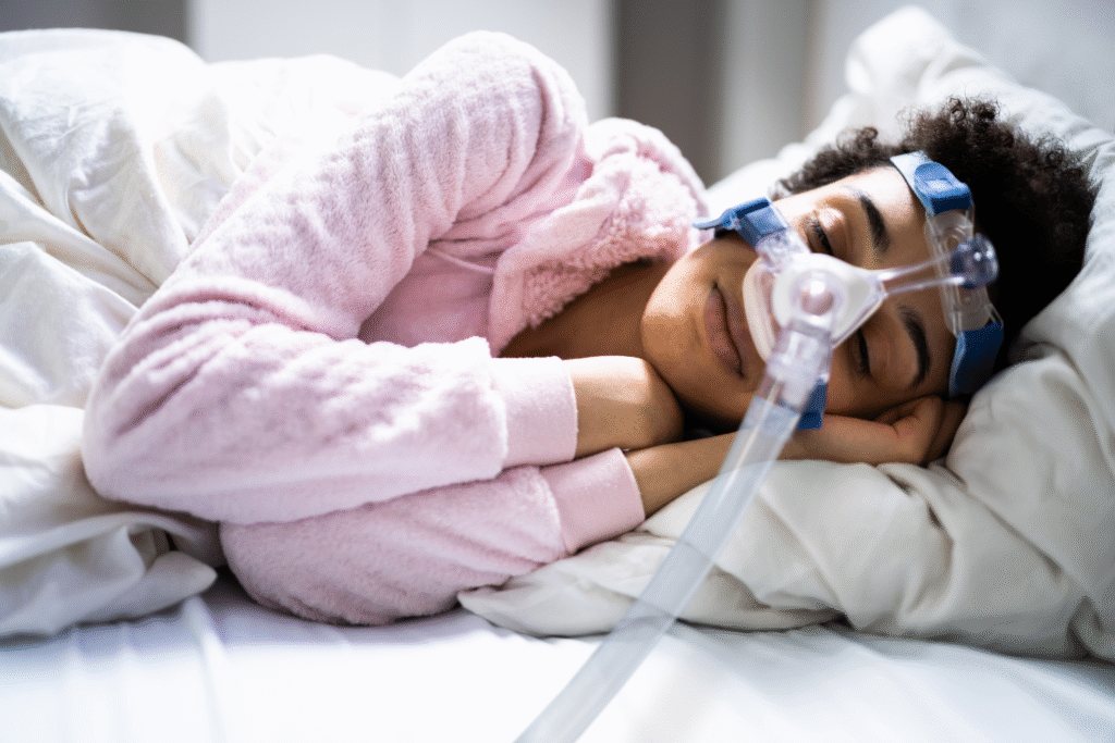 Man sleeping with CPAP machine for sleep apnea treatment