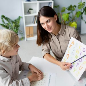 Child receiving speech and occupational therapy from a licensed therapist in a clinical setting.